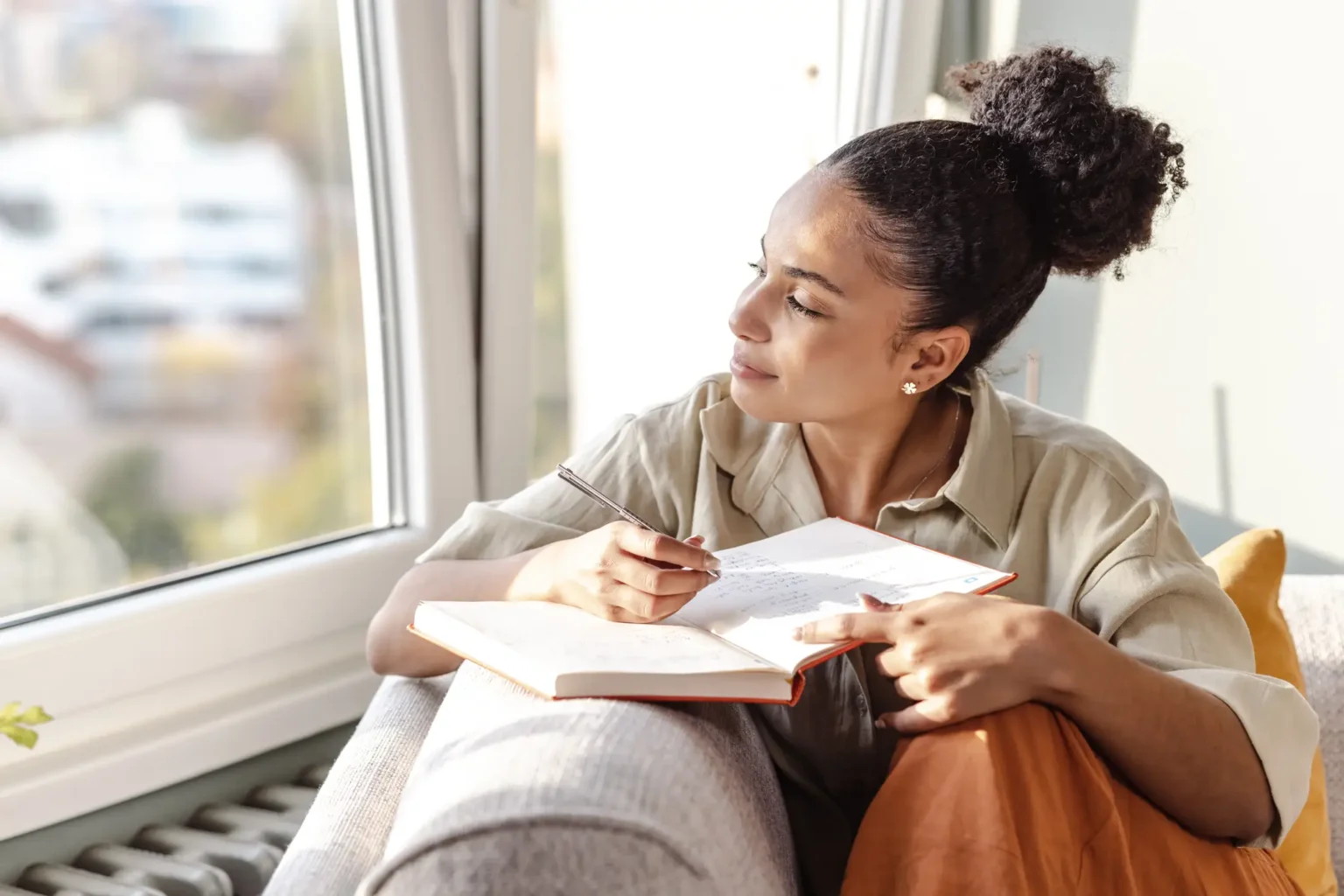 Caregiver writing an entry in a journal