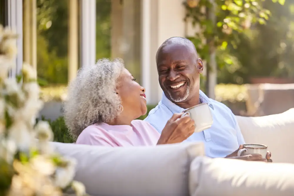 a senior couple drinking coffee on their patio