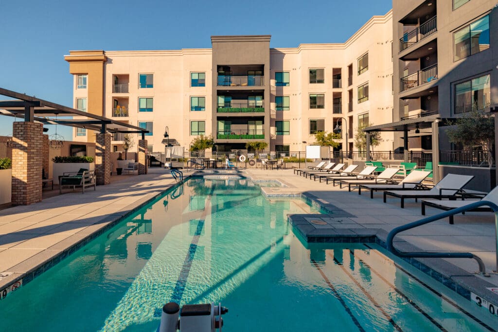 A wide-shot of the pool at Clarendale Arcadia, showing senior's summer social life made easy in Phoenix, AZ.