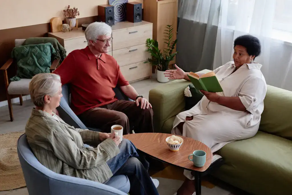 A senior group discussing book club books at Clarendale Arcadia in Phoenix, AZ.