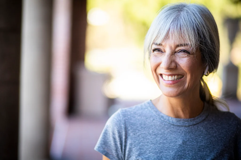 A senior woman smiling from her home at Clarendale Arcadia, a senior living community in Phoenix, AZ.