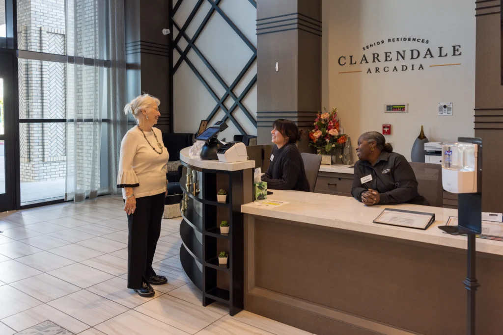 A senior at the front desk of Clarendale Arcadia, a multi-award winning community for best memory care in Phoenix, AZ. 