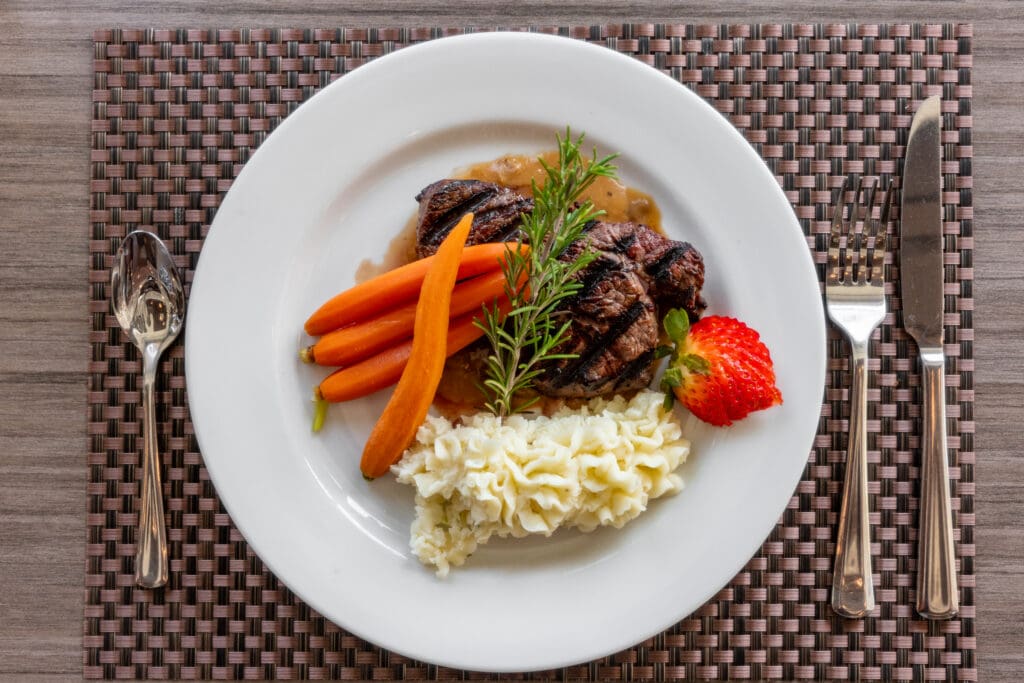 senior health on a plate: steak, carrots and rice at Clarendale showing senior living dining at Clarendale Arcadia in Phoenix, AZ.
