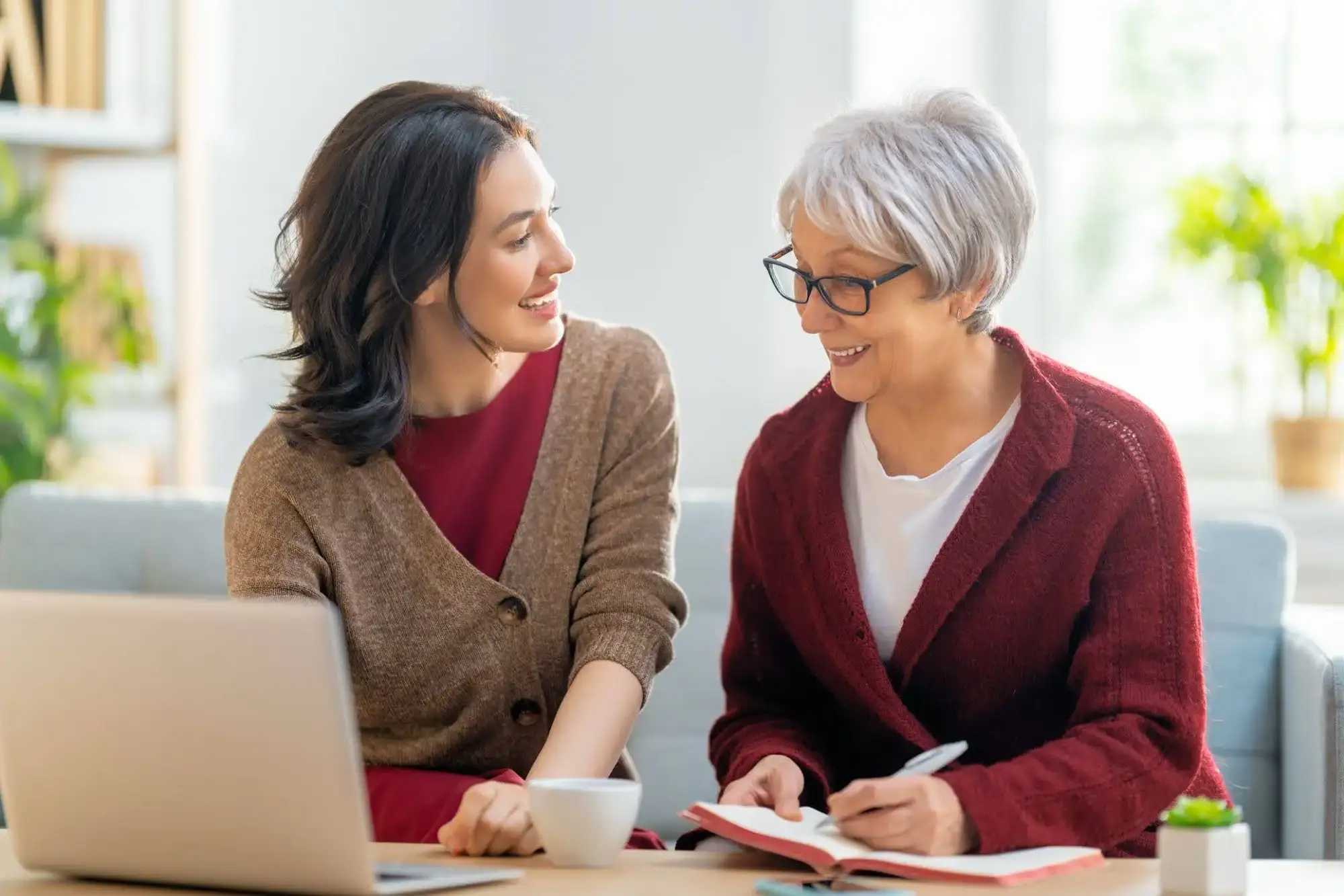 A senior woman sitting down with her adult daughter to talking about getting started with Assisted Living in Phoenix at Clarendale Arcadia.