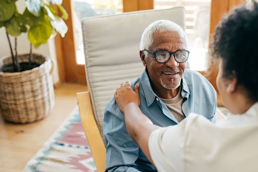 A caregiver from the SafelyYou® program at Clarendale Arcadia in Phoenix, AZ providing personalized advanced senior care to a resident.