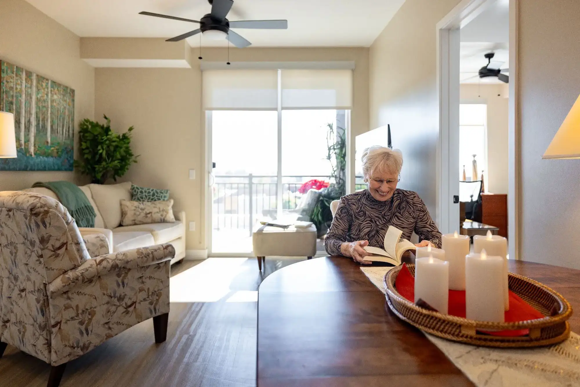 An elderly woman sitting down and looking through her downsizing checklist for seniors in order to prepare to make the move for senior living in Phoenix, AZ.
